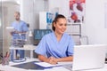 Smiling nurse using laptop computer Royalty Free Stock Photo