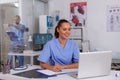 Smiling nurse using laptop computer Royalty Free Stock Photo