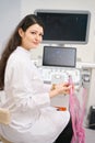 Smiling nurse working on ultrasound scanner in the clinic Royalty Free Stock Photo