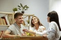 Smiling nutritionist showing a healthy diet plan to patient