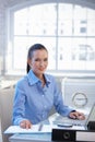 Smiling office girl busy at desk