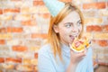 Smiling office lady, at lunchtime and eating pizza. Festive atmosphere. Royalty Free Stock Photo