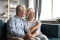 Smiling old couple hug look in distance dreaming Royalty Free Stock Photo