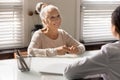 Smiling old female patient talk with doctor Royalty Free Stock Photo