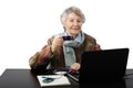 Smiling old lady drinking cup of coffee while teleworking Royalty Free Stock Photo