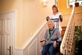 Smiling old lady, happy while nurse helps her to climb to the st Royalty Free Stock Photo