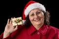 Smiling Old Lady Shows Golden Wrapped Christmas Gift