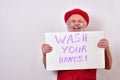 Man hold up sign that says Wash Your Hands Royalty Free Stock Photo