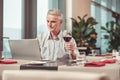 Smiling old man drinking a good wine Royalty Free Stock Photo