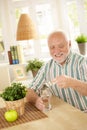 Smiling old man taking medication Royalty Free Stock Photo