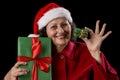 Smiling Old Woman Offering a Small and a Big Gift Royalty Free Stock Photo