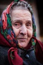 Smiling old woman with a scarf