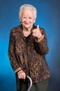 Smiling old woman standing with a cane Royalty Free Stock Photo