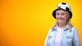 Smiling old woman wearing funny football hat, template for ad, sport betting Royalty Free Stock Photo