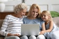 Happy three generations family looking at laptop screen. Royalty Free Stock Photo