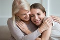 Happy smiling older mother and adult daughter hugging and laughing