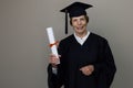 older woman graduate in graduation gown holding diploma Royalty Free Stock Photo