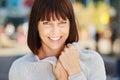 Smiling older woman holding soft sweater Royalty Free Stock Photo
