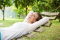 Smiling older woman relaxing on hammock outdoors