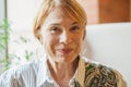 Smiling older woman with short ginger hair portrait