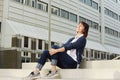 Smiling older woman sitting on steps in city Royalty Free Stock Photo