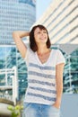 Smiling older woman standing in city with hand in hair Royalty Free Stock Photo