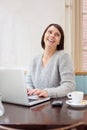 Smiling older woman using laptop at home Royalty Free Stock Photo