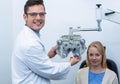 Smiling optometrist examining female patient on phoropter Royalty Free Stock Photo