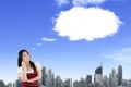 Smiling oriental woman thinking and looking up with blank bubble speech