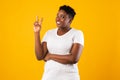 Smiling Oversized Black Woman Gesturing V-Sign Standing Over Yellow Background