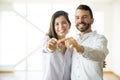 Smiling Owners Showing Keys Of Their New Apartment