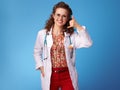 Smiling paediatrician doctor showing call me gesture on blue Royalty Free Stock Photo