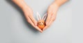 Smiling painted Easter egg bunny in hands