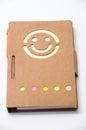 Smiling paper notebook on the white background