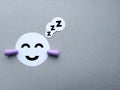 Smiling paper sleeping face with earplugs. Earplugs - noise protection