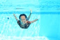 Smiling Papuan woman swimming in pool in brown dress Royalty Free Stock Photo