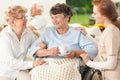 Smiling paralyzed senior woman with friend and nurse Royalty Free Stock Photo