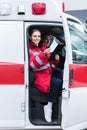 smiling paramedic sitting in ambulance Royalty Free Stock Photo