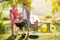 Smiling parent grilling meat with daughter Royalty Free Stock Photo