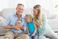 Smiling parents and daughter sitting with rabbit together Royalty Free Stock Photo