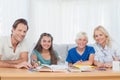 Smiling parents helping their children with their homework Royalty Free Stock Photo