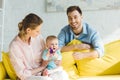 Smiling parents and infant daughter playing Royalty Free Stock Photo