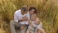 Smiling parents and child playing on a wheat field Royalty Free Stock Photo
