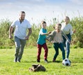 Smiling parents with two kids playing soccer Royalty Free Stock Photo