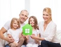 Smiling parents and two little girls at new home