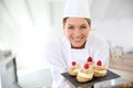Smiling pastry chef with deserts Royalty Free Stock Photo