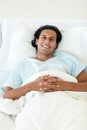 Smiling patient lying on a hospital bed Royalty Free Stock Photo
