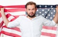 Smiling patriotic man holding United States flag. USA celebrate 4th July. Royalty Free Stock Photo