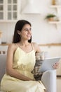 Smiling peaceful woman enjoy pastime at home using digital tablet Royalty Free Stock Photo