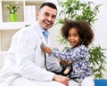 Smiling pediatrician and his happy little patient Royalty Free Stock Photo